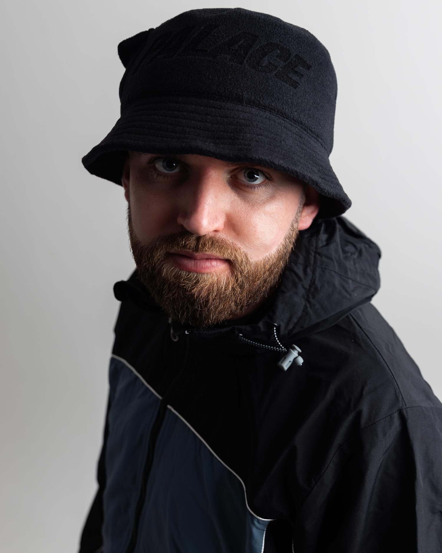 Gaskin wearing a black bucket hat and jacket against a plain background