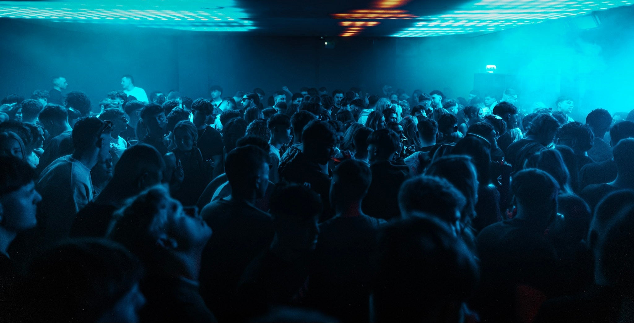 Crowd at a Bass Jamz gig with blue lighting