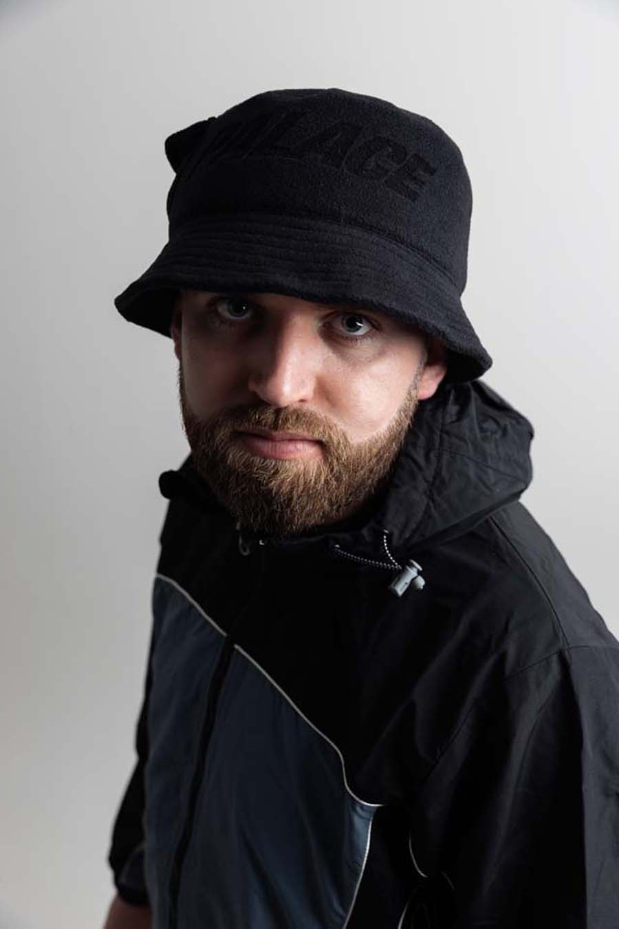 Gaskin wearing a black bucket hat and jacket against a plain background