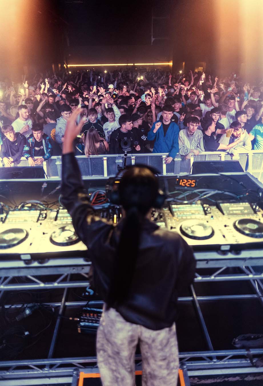 Ellia Jaya at a music event with crowd and equipment