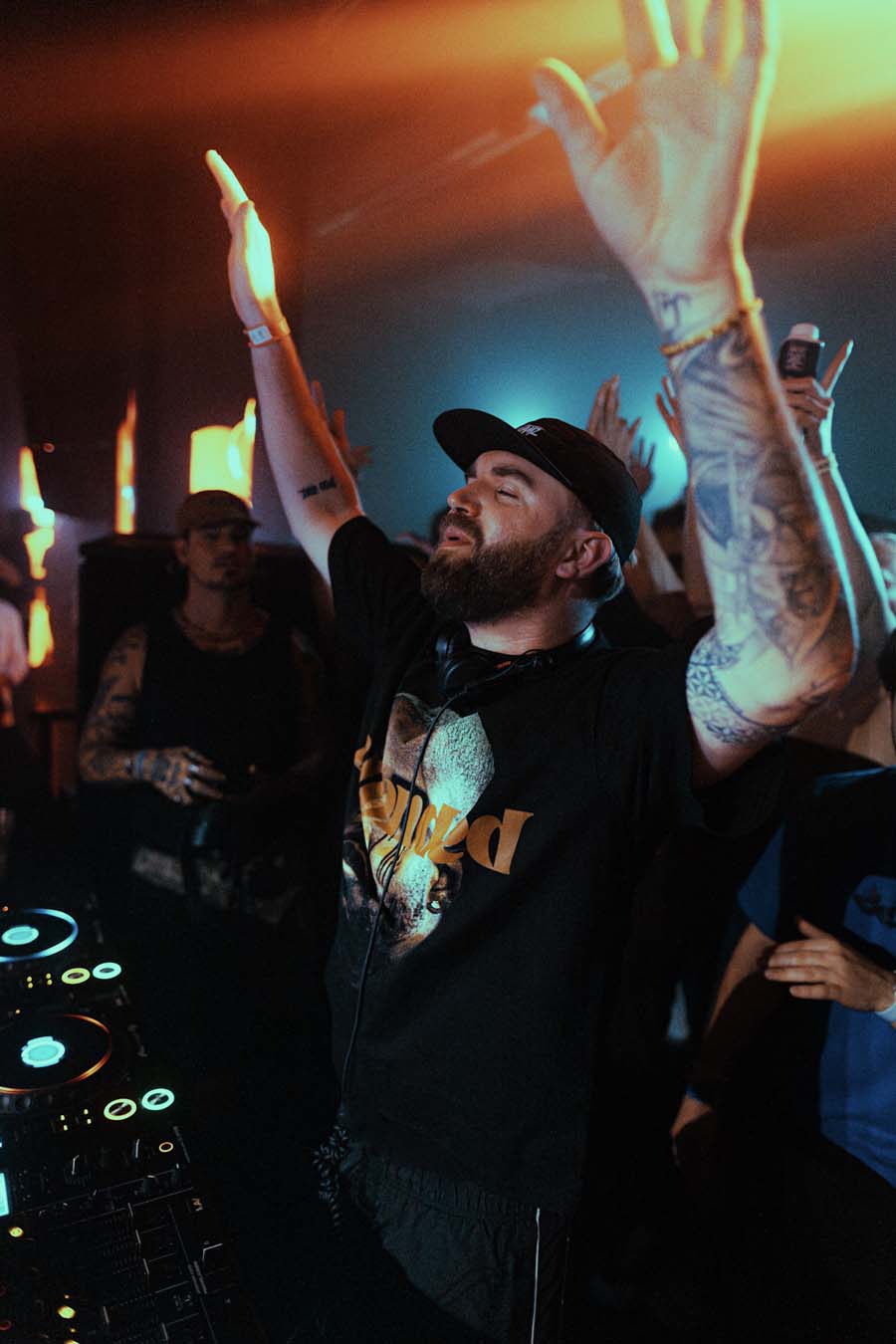 Gaskin at a concert with arms raised, surrounded by people and stage lights.