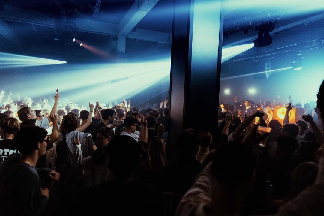 Large screen displaying a space scene with a crowd of people watching.
